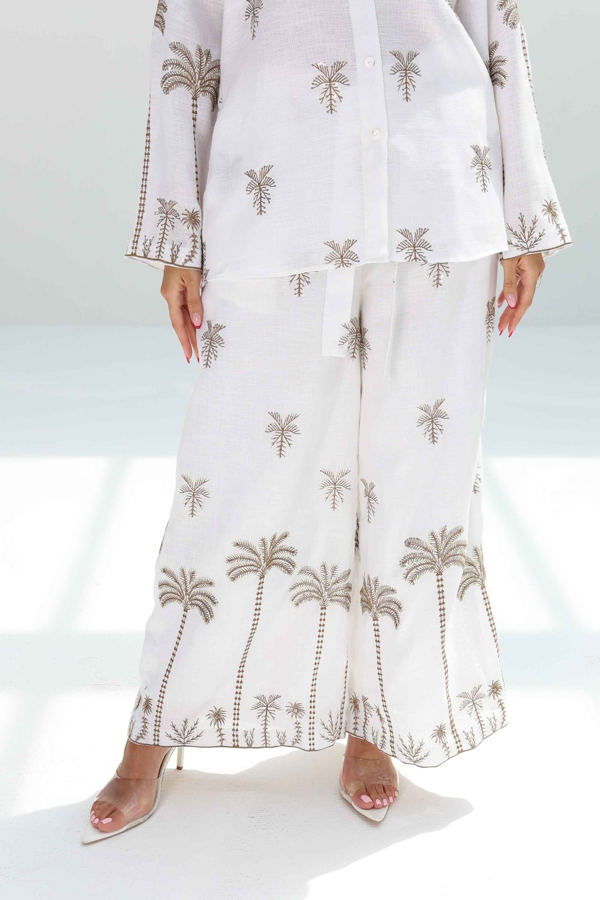 Wide-leg trousers of the Golden Oasis Linen Blend Co-ord Set featuring a refined palm print design