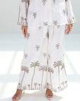 Wide-leg trousers of the Golden Oasis Linen Blend Co-ord Set featuring a refined palm print design