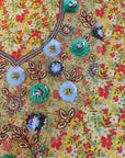 Premium printed cotton fabric displaying the golden wildflower pattern of the Golden Wildflower Cotton Mukhawar for custom tailoring by Gharza Couture.