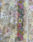 Premium printed cotton fabric displaying the elegant floral pattern of the Ivory Blossom Cotton Mukhawar for custom tailoring by Gharza Couture.