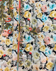 Premium printed cotton fabric displaying the ivory floral and paisley pattern of the Ivory Paisley Bloom Cotton Mukhawar for custom tailoring by Gharza Couture.