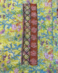 Premium Liberty cotton fabric displaying the vibrant lime floral print of the Lime Liberty Cotton Mukhawar for custom tailoring by Gharza Couture.