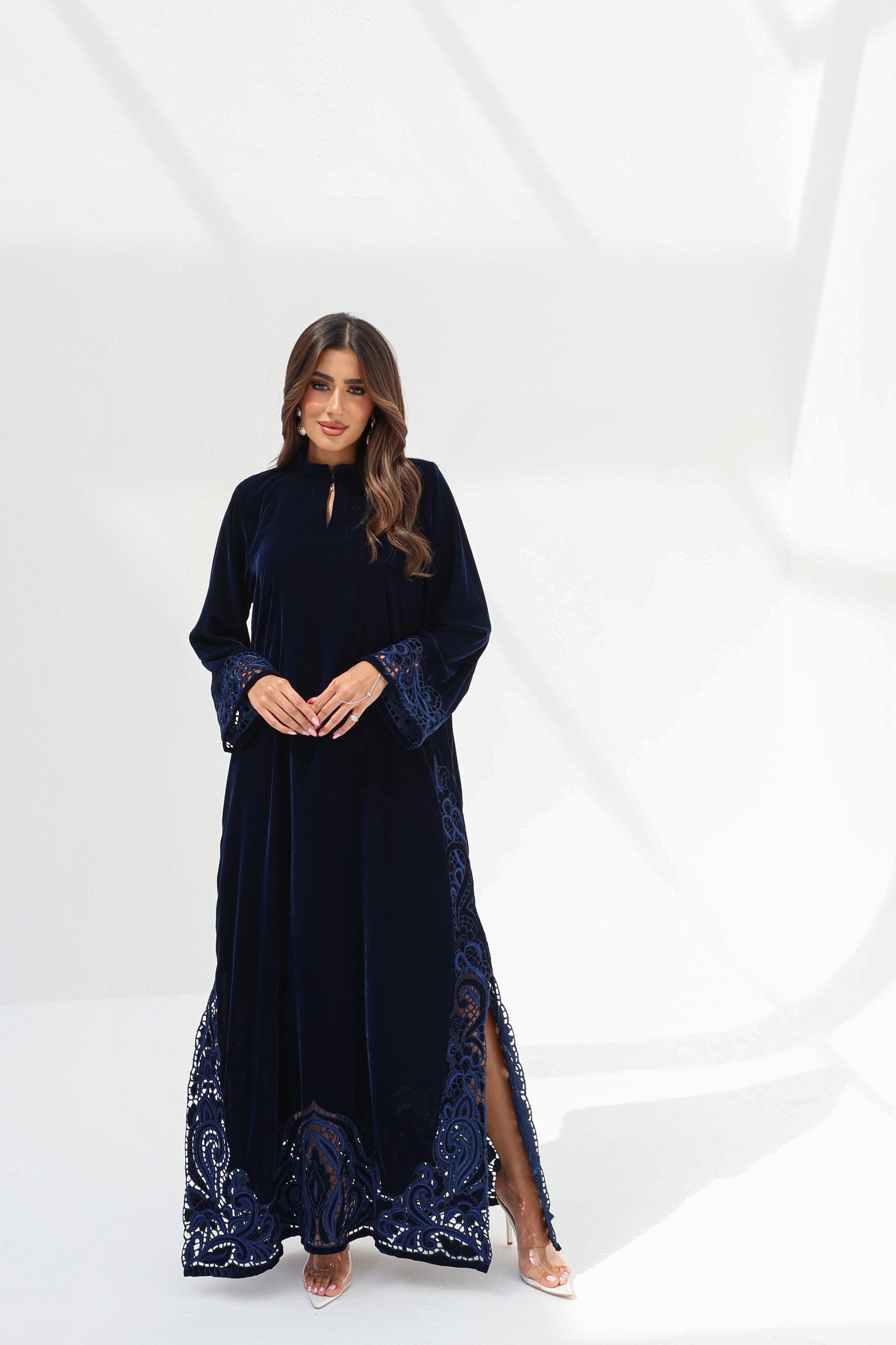 Full-length styled view of midnight navy velvet jalabiya with hand-embroidered cuffs and hem
