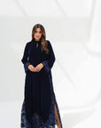 Full-length styled view of midnight navy velvet jalabiya with hand-embroidered cuffs and hem
