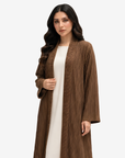 Close-up of the Mocha Pleated Open Crepe Abaya highlighting textured pleated crepe fabric and elegant shawl collar detailing.