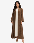 Mocha Pleated Open Crepe Abaya by Gharza Couture featuring premium textured pleated fabric and a flowing full-length modest silhouette.