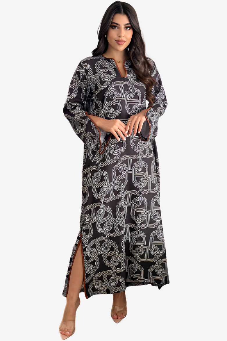 A woman modeling a long-sleeved maxi dress with a dark gray and light gray geometric interlocking pattern, set against a plain light gray background.