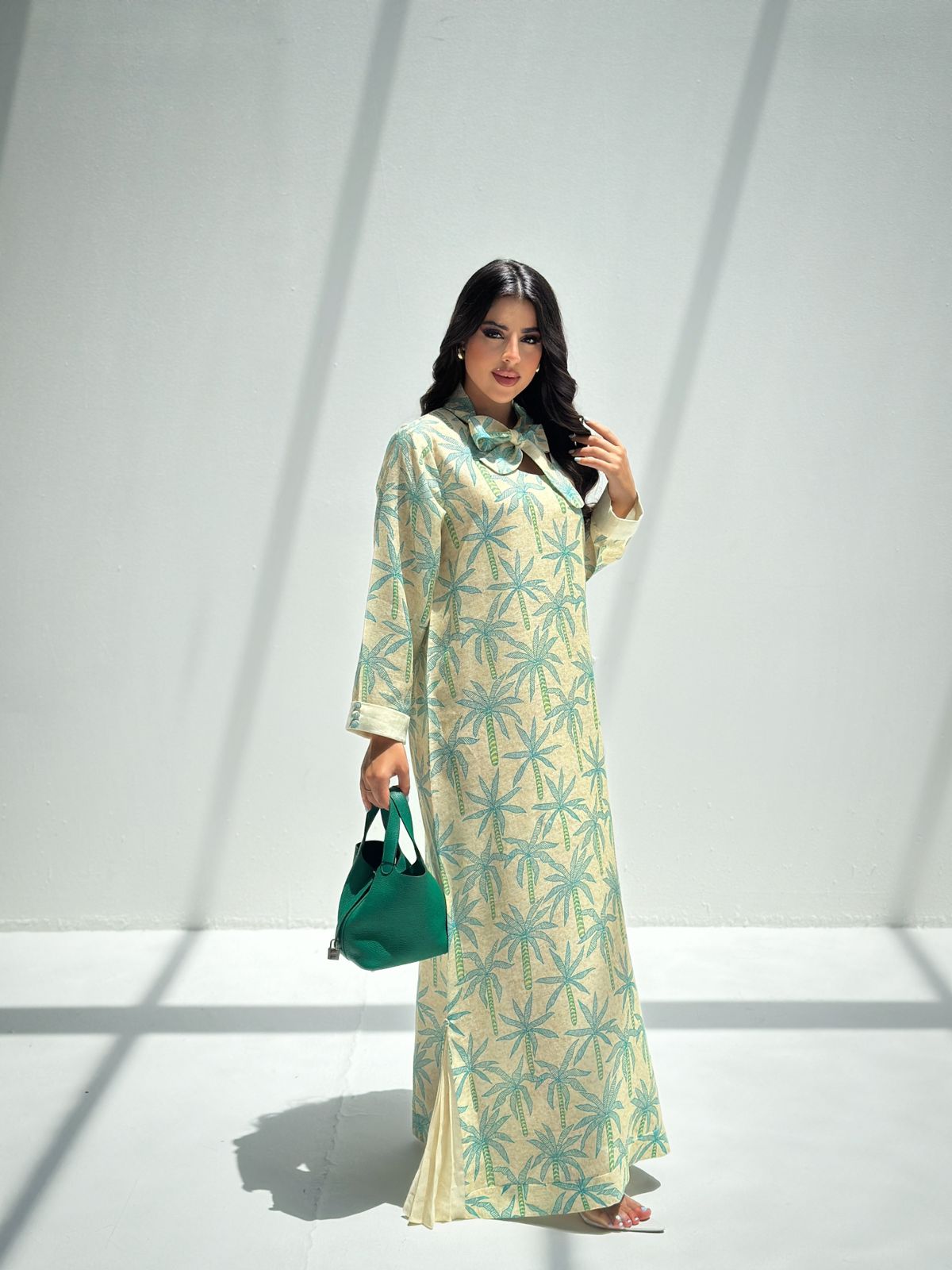 Full-length Palm Canopy Bow Neck Jalabiya with teal palm print, pleated hem and flowing modest silhouette
