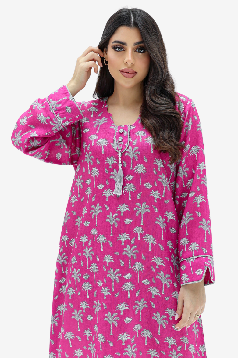 A woman modeling a bright pink long kurta dress with a white palm tree pattern, set against a plain light gray background.
