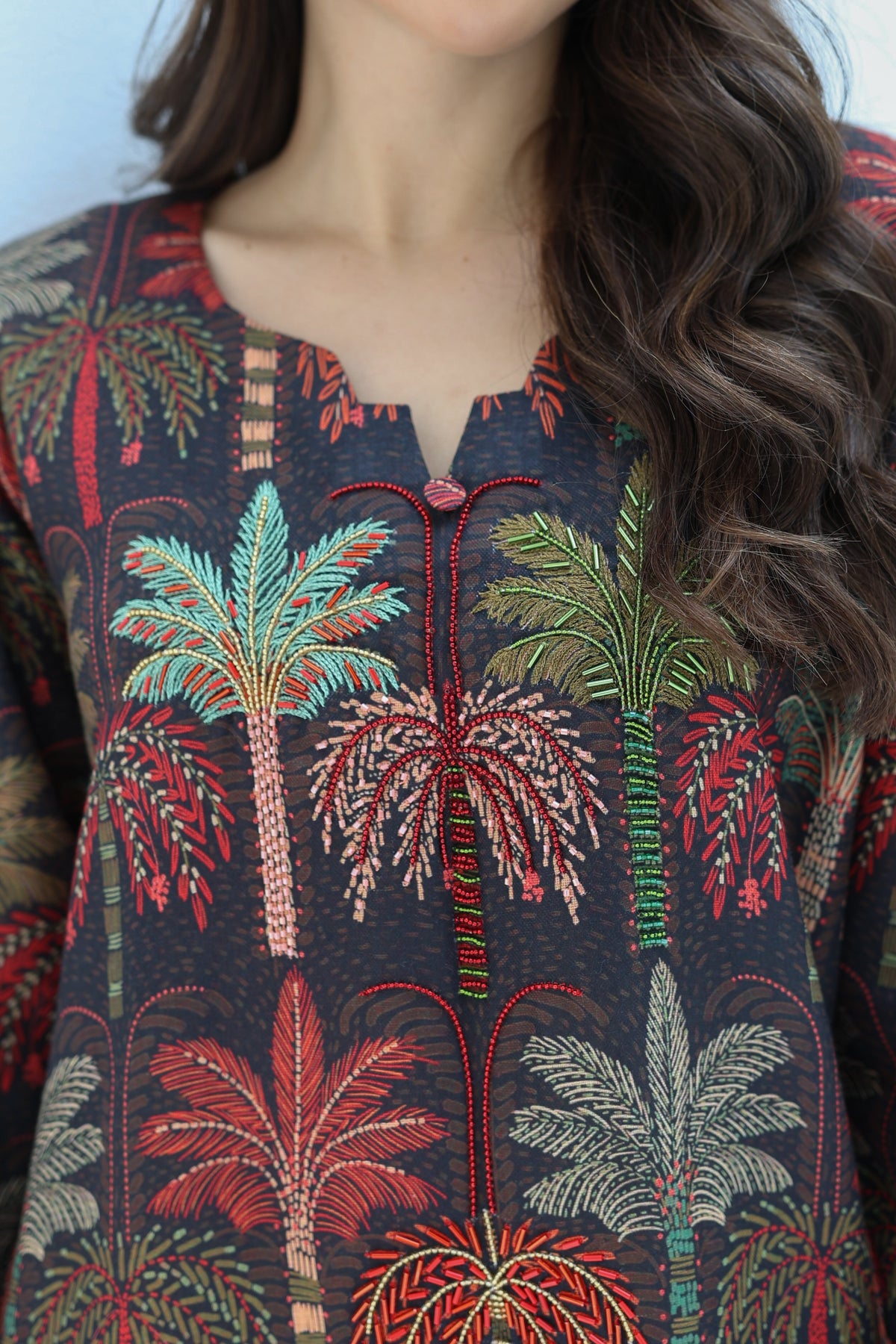 Close-up of black and red floral print fabric on a maxi dress