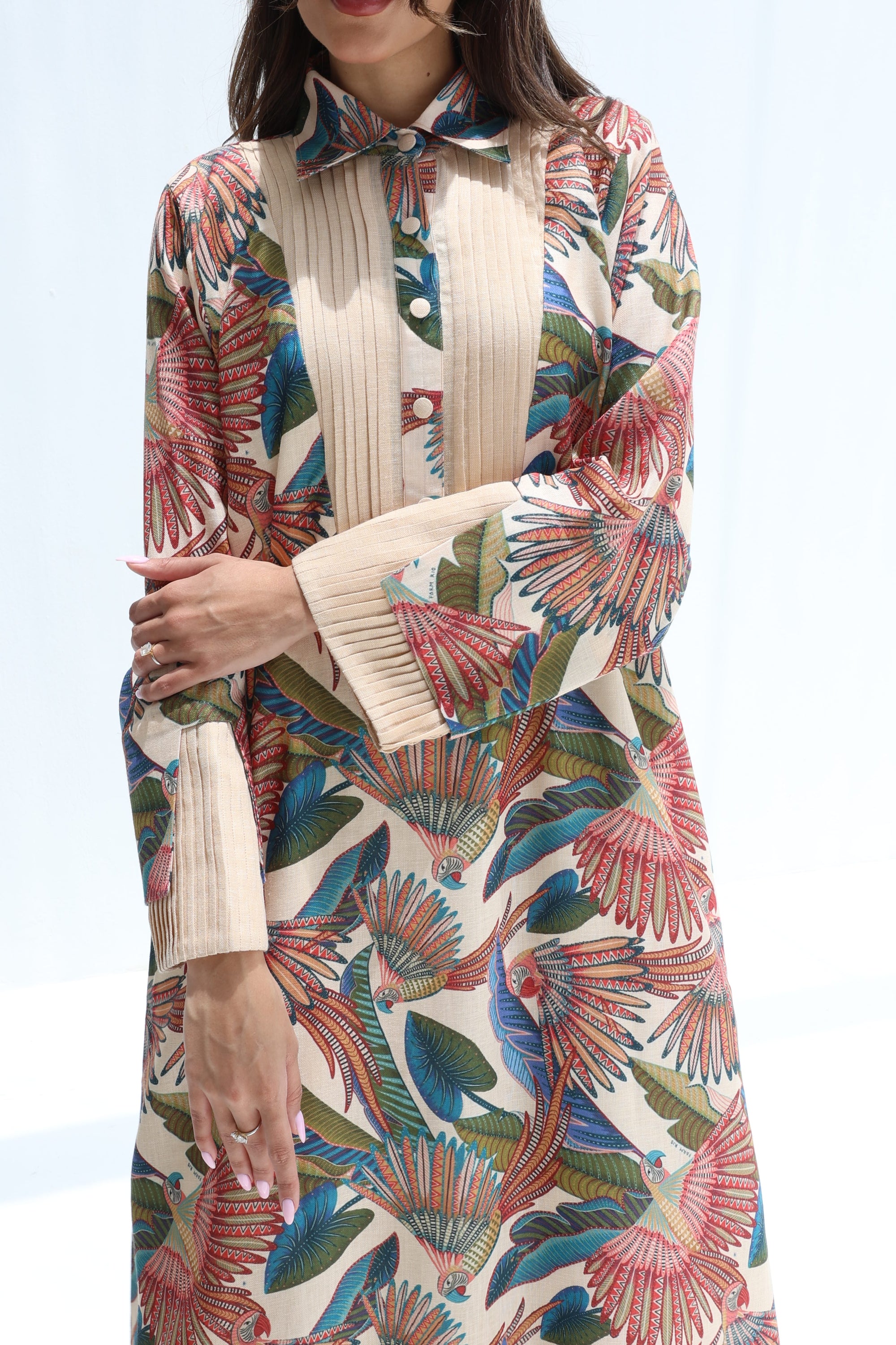 Close-up of the pleated front panel, shirt collar and tropical bird print on the Paradise Plume jalabiya