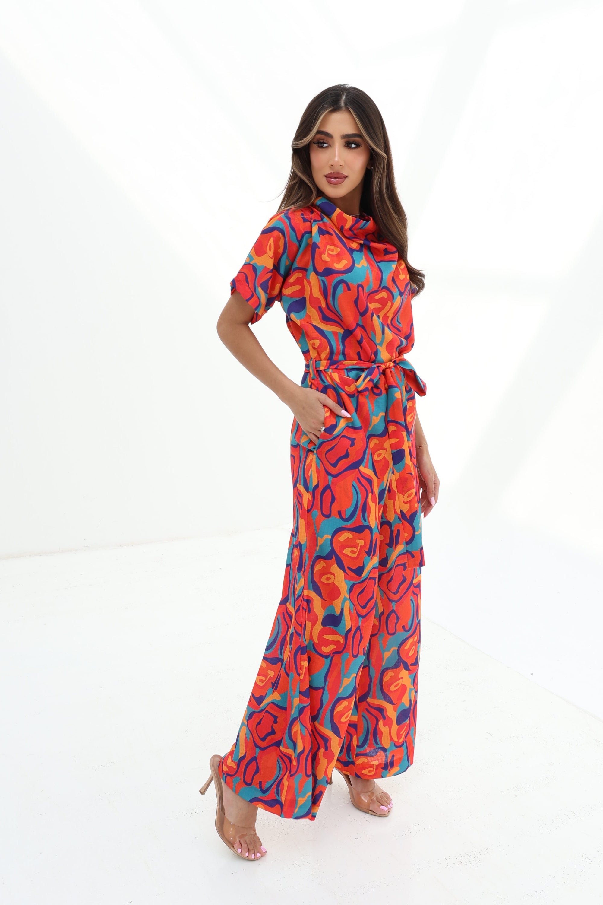 Side profile of the Prism Flow Sunset Abstract Linen Blend Jumpsuit showcasing the flowing wide-leg fit and breathable linen blend fabric.