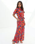 Side profile of the Prism Flow Sunset Abstract Linen Blend Jumpsuit showcasing the flowing wide-leg fit and breathable linen blend fabric.