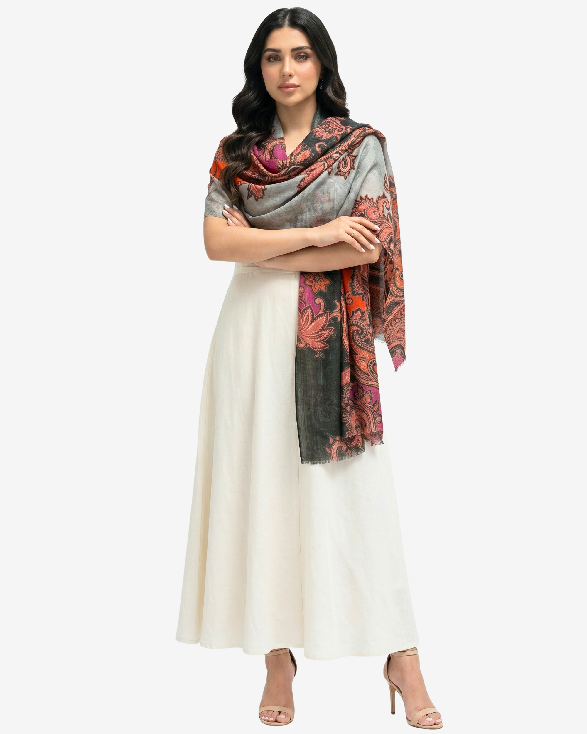 A woman modeling a cream-colored traditional dress with a draped multicolor scarf featuring orange, red, and gray paisley patterns, set against a plain light gray background.