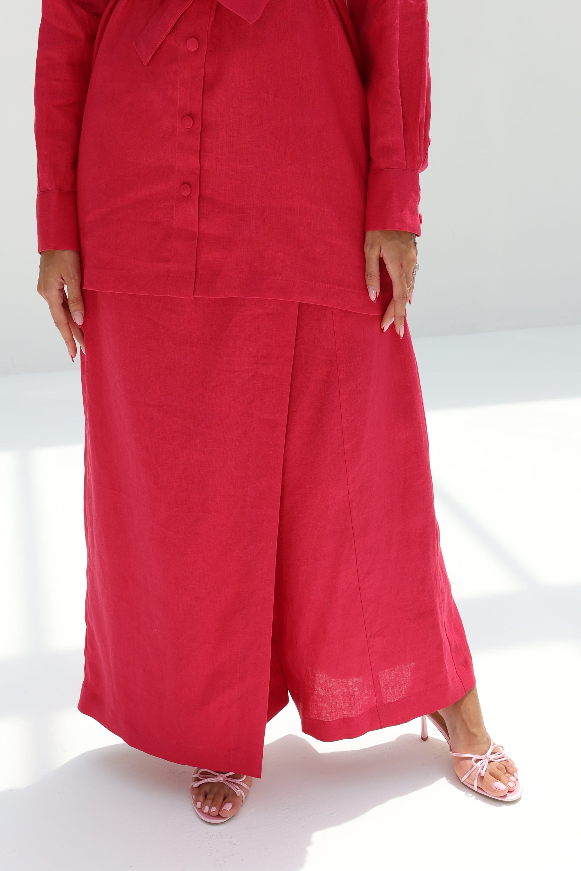 Lower front view of Ruby Essence Linen Blend Co-ord Set highlighting the matching wide-leg trousers and elegant drape.
