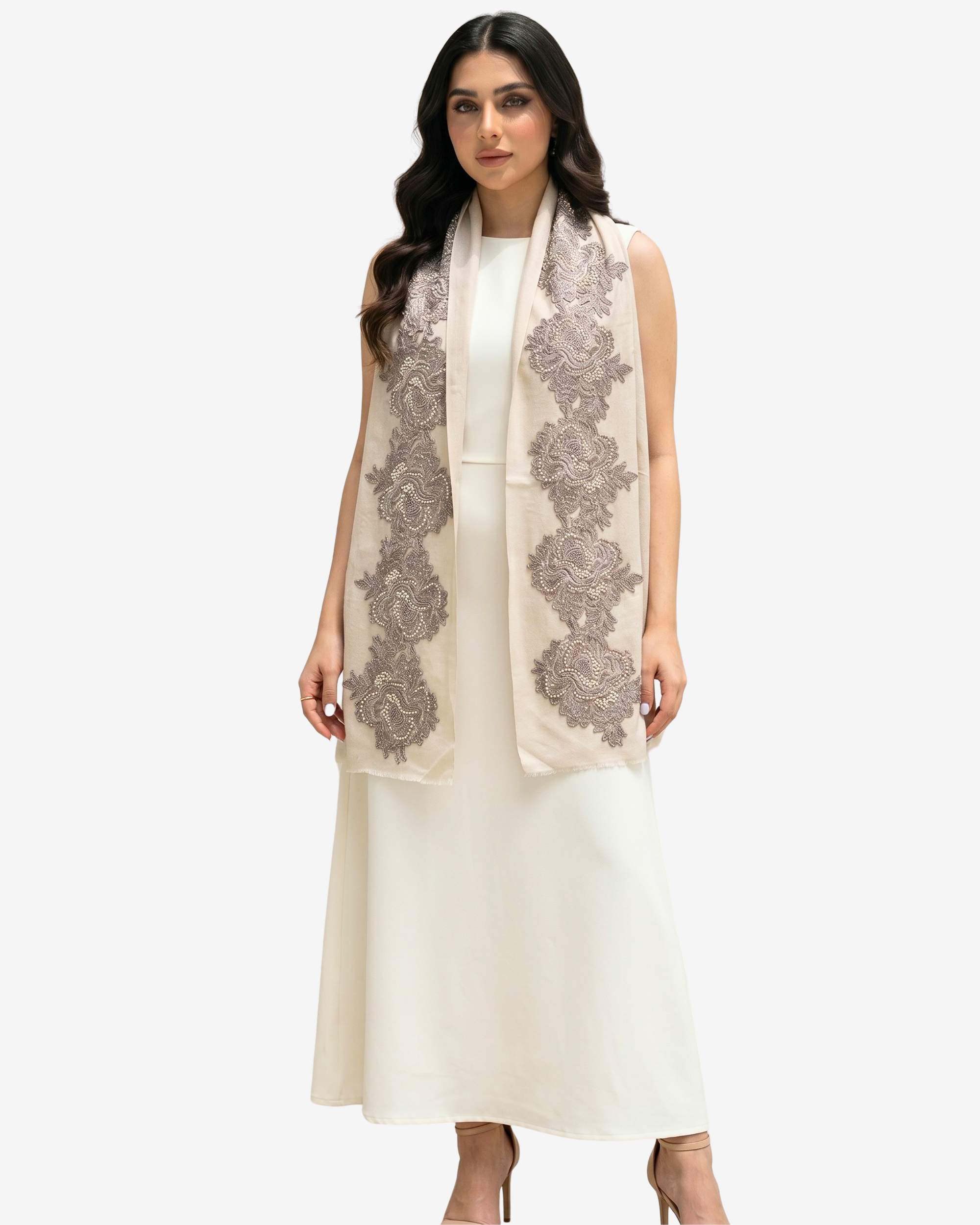 A woman modeling a sleeveless cream dress with a matching draped scarf featuring large gray floral lace patterns, set against a plain light gray background.