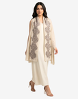 A woman modeling a cream-colored traditional outfit with a matching draped shawl featuring gray floral embroidery, paired with nude high-heeled sandals against a light gray background.