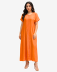 Sunset Glow Pleated Maxi Dress in vibrant orange featuring a flowing silhouette, front pleat detailing, and round neckline.