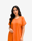 Half Body view of the Sunset Glow Pleated Maxi Dress highlighting the relaxed fit and graceful drape.