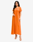 Angled view of the Sunset Glow Pleated Maxi Dress highlighting the relaxed fit and graceful drape.