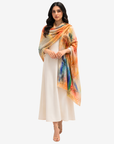 Sunset Gallery Cashmere Silk Scarf wrapped around the shoulders, highlighting the warm multicolor print