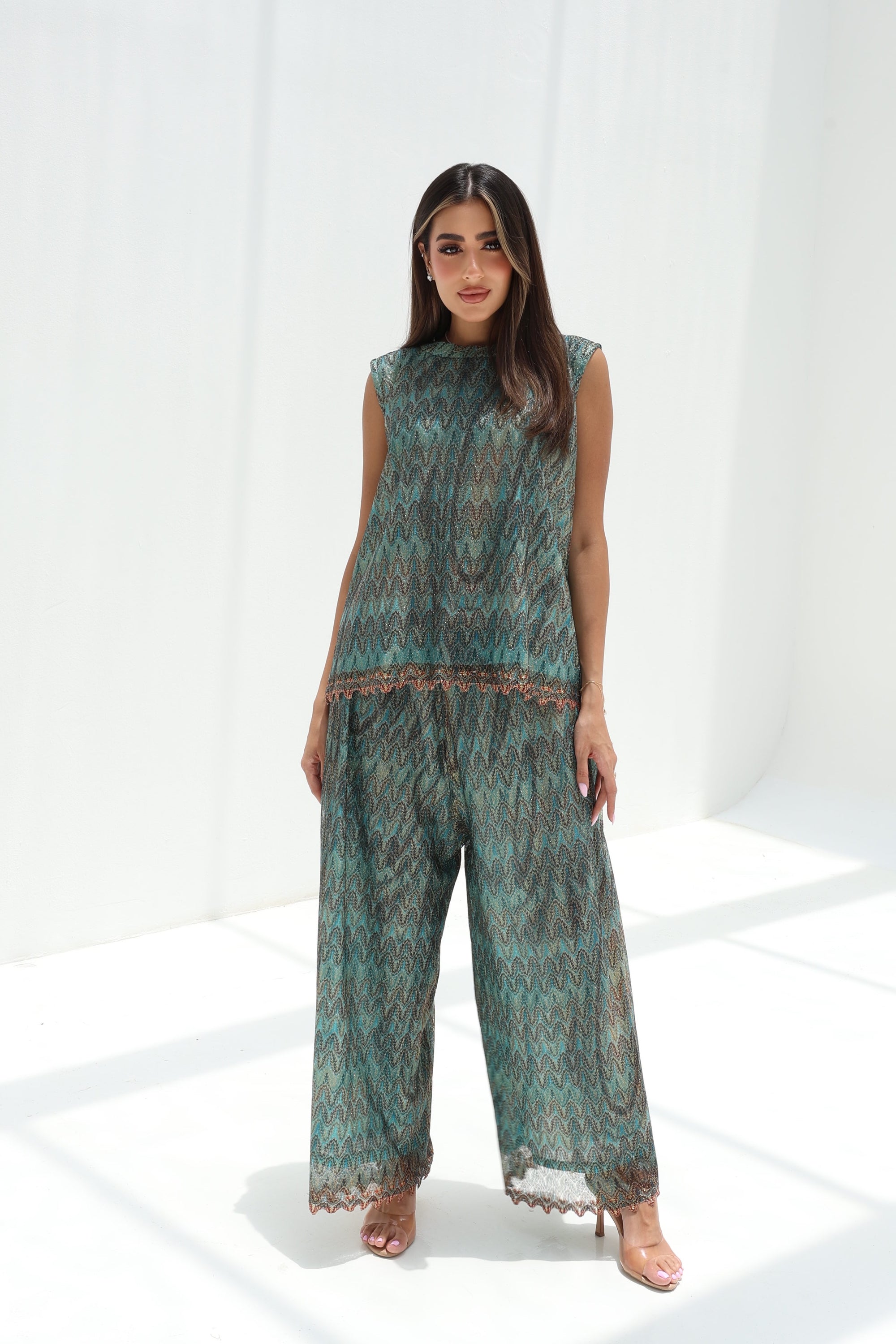 Teal mosaic lace sleeveless top and wide-leg trousers with copper-toned accents