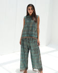 Teal mosaic lace sleeveless top and wide-leg trousers with copper-toned accents