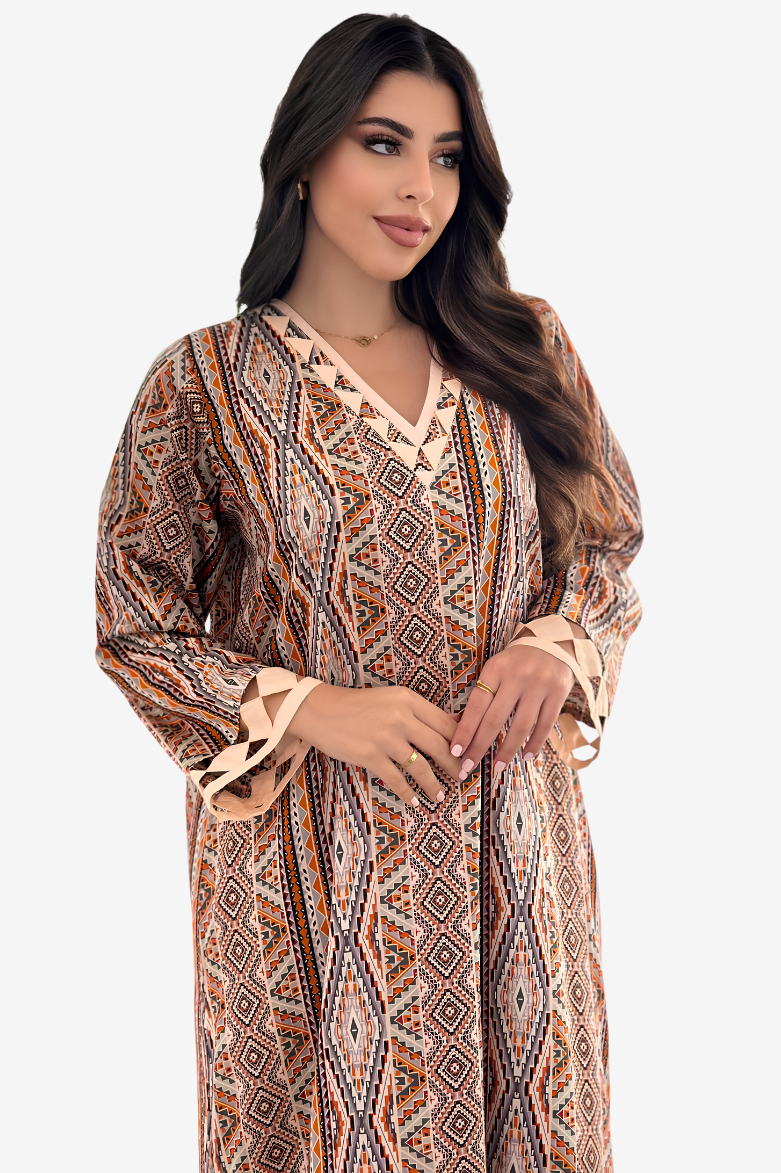 A woman modeling a long-sleeve bohemian-style maxi dress with a geometric tribal print in brown, beige, and orange tones, featuring a V-neckline and ruffled cuffs, set against a plain light gray background.