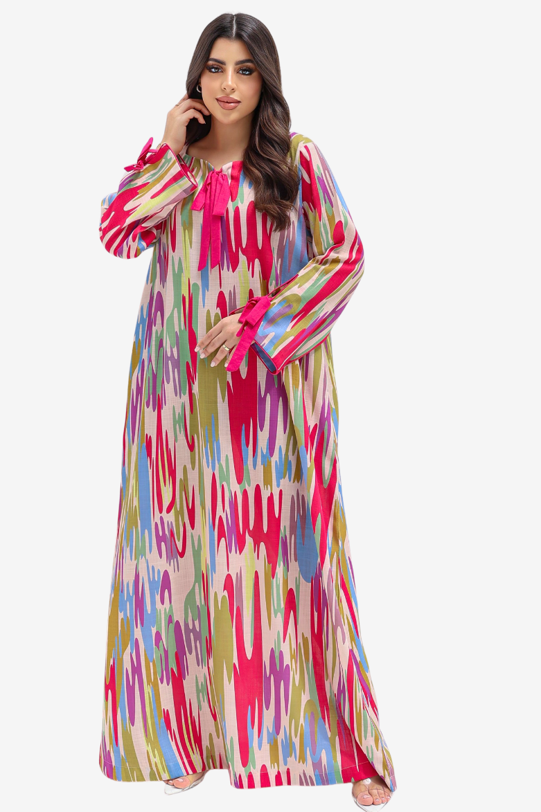 A woman modeling a long, flowing abaya dress with a vibrant multicolor ikat pattern in pink, blue, green, and yellow on a cream base, set against a plain light gray background.