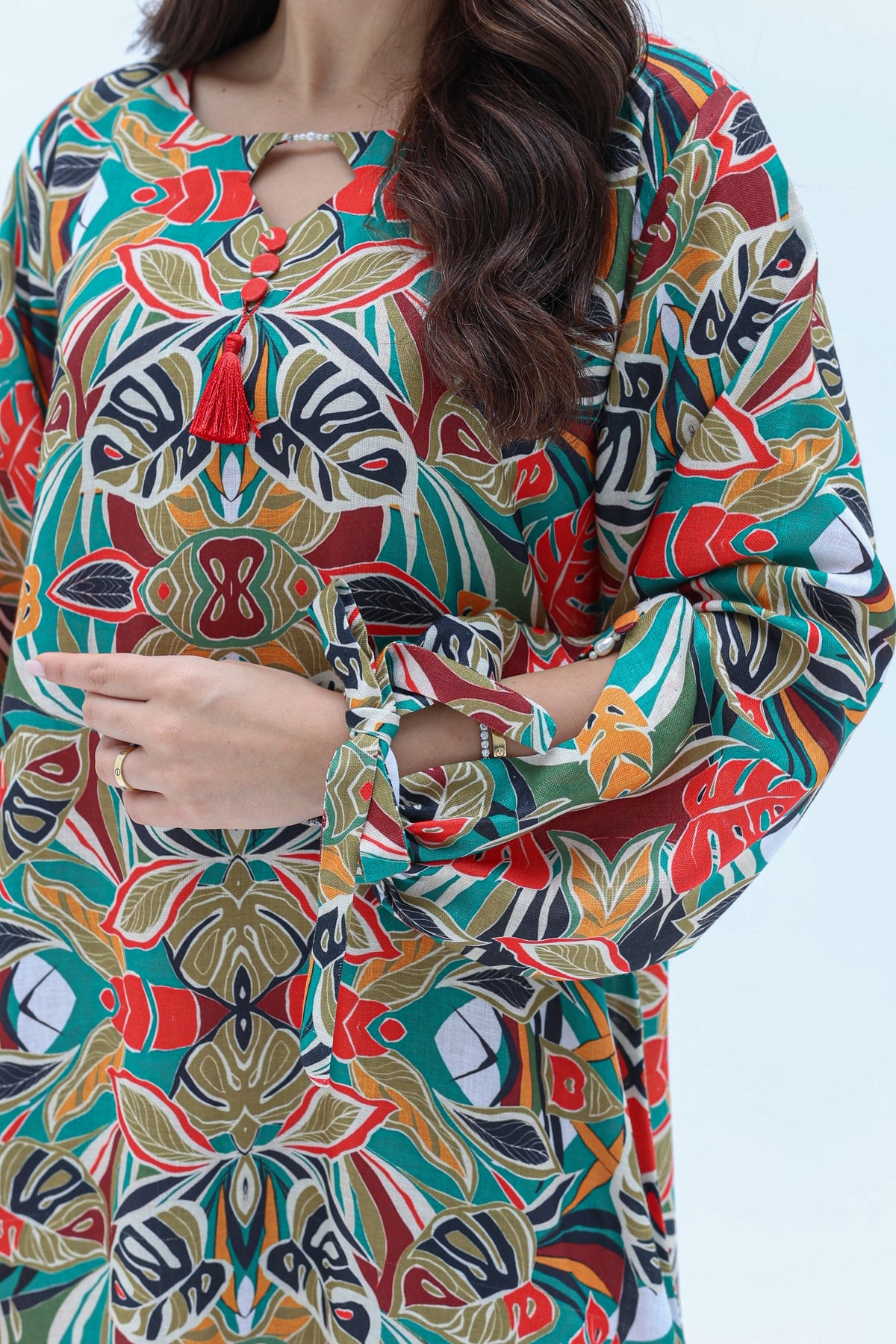 Close-up view of Tropical Mosaic jalabiya showing its colourful print and sleeve details