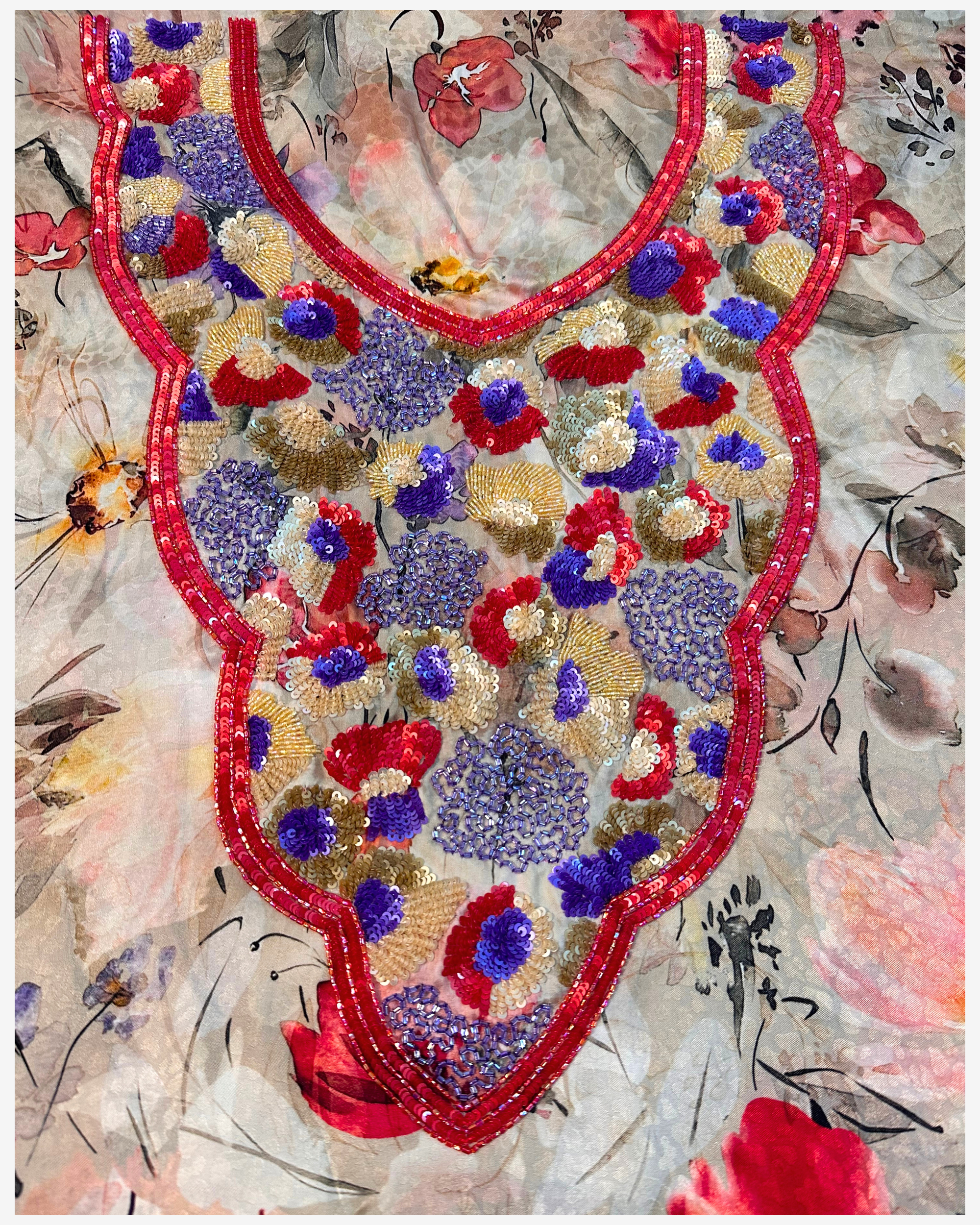 Close-up of Crimson Garden silk fabric with red purple and gold hand bead and sequin embellishment