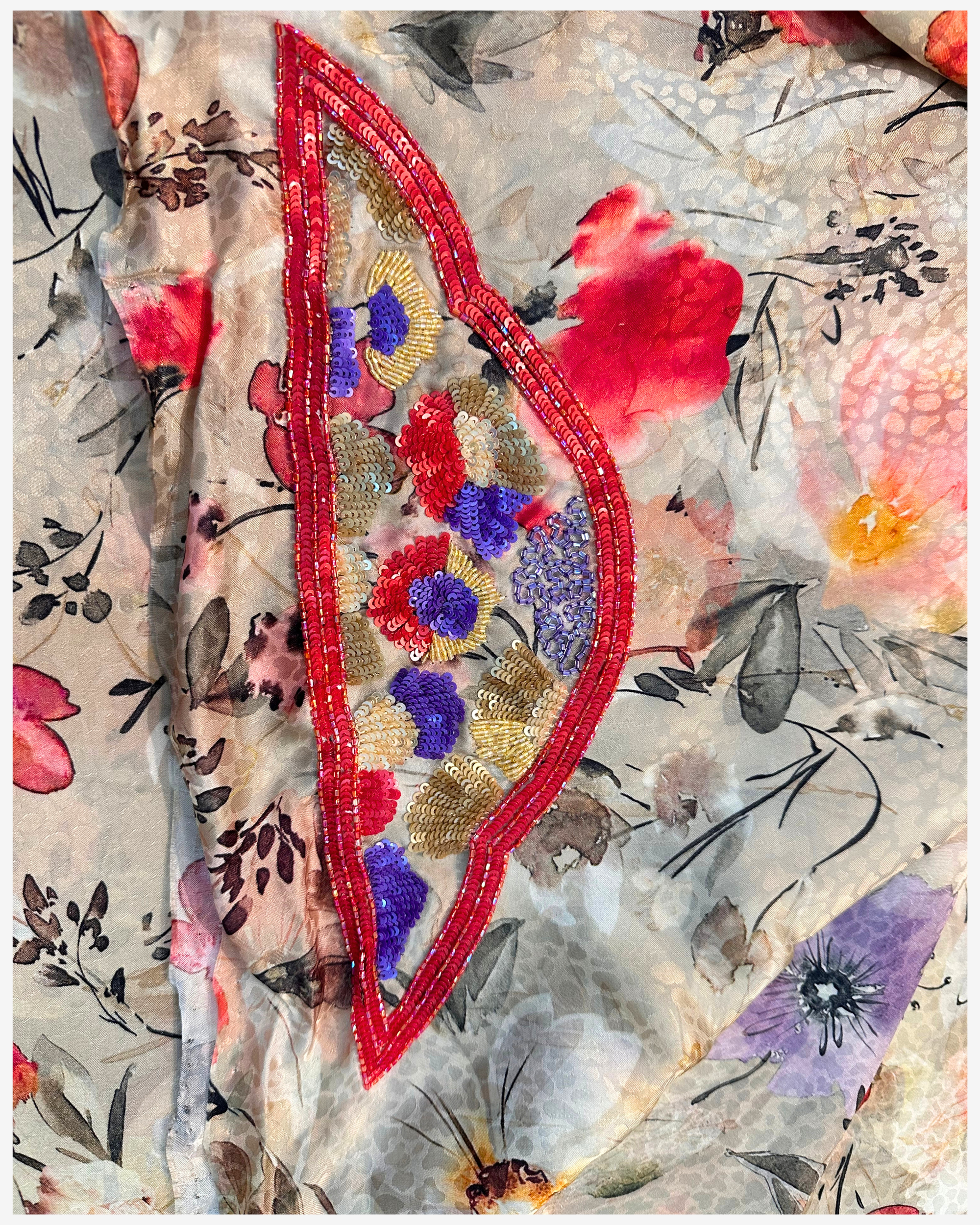 Folded Crimson Garden floral silk unstitched fabric showing hand embellished bead and sequin detailing