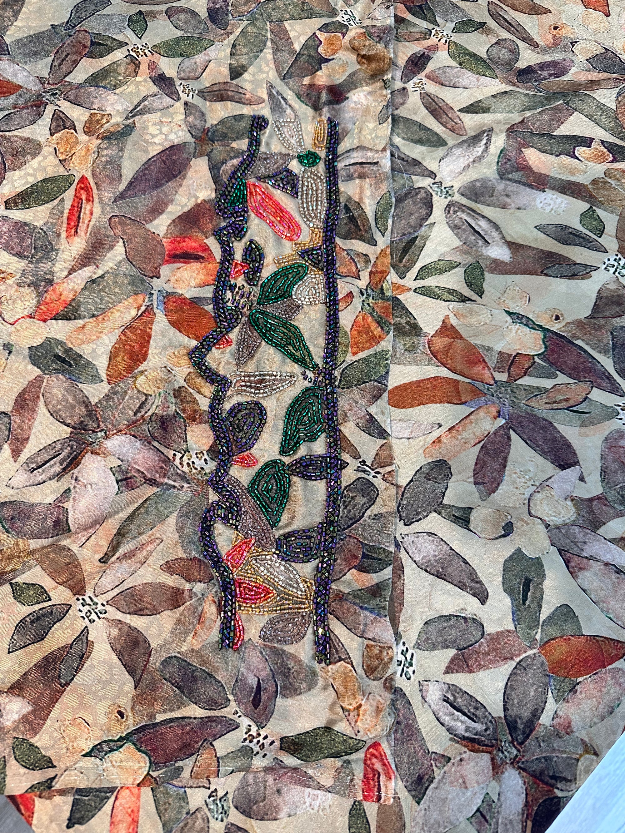 Emerald Botanica printed silk fabric with coordinating hand beaded leaf embellishment detail