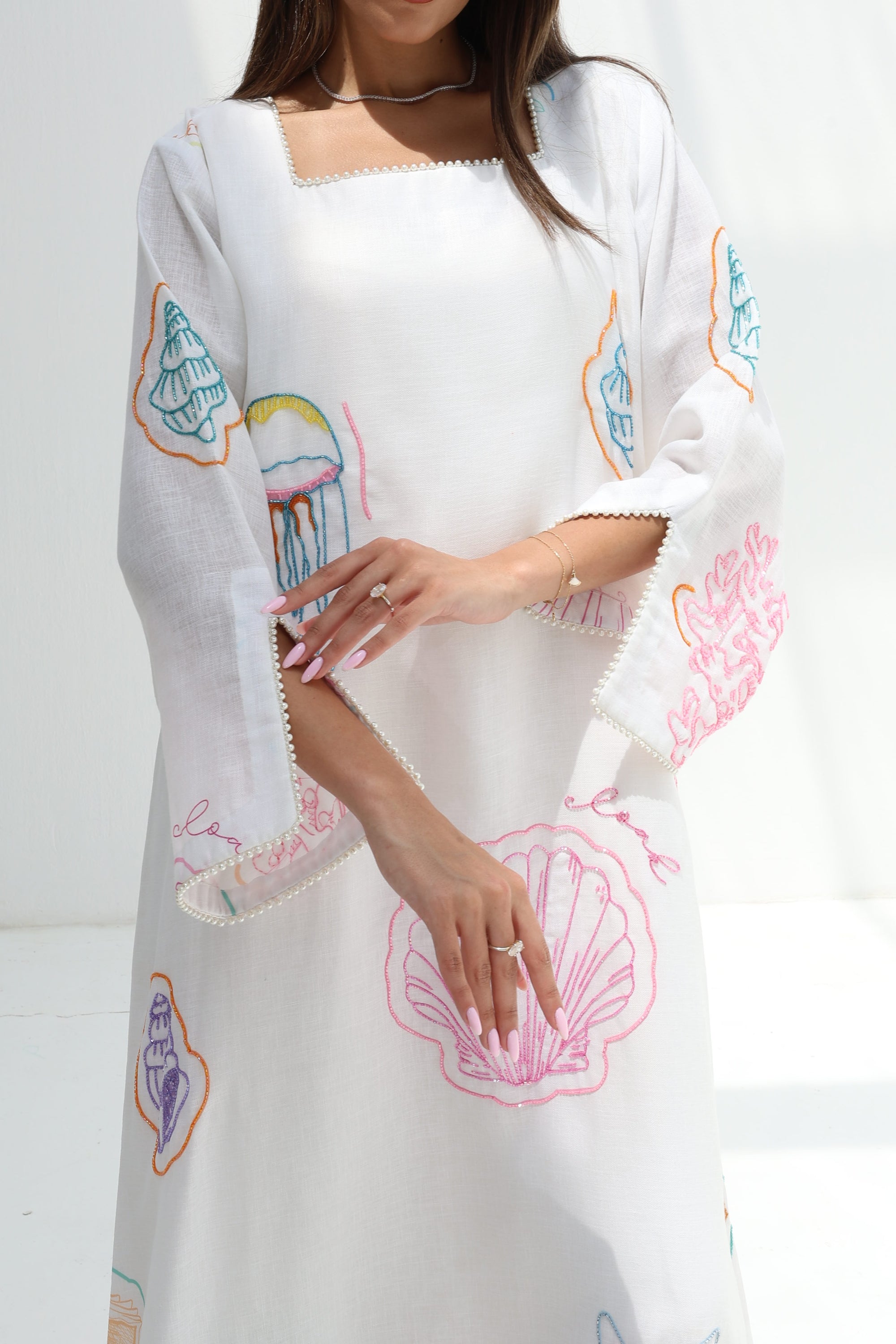 Close-up of Seashell Embellished Linen Blend Jalabiya highlighting sleeve and embellished coastal motifs