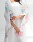 Close-up of Seashell Embellished Linen Blend Jalabiya highlighting sleeve and embellished coastal motifs