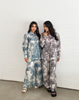 Women's palm print travel wear set with elastic waist trousers and relaxed fit silhouette.