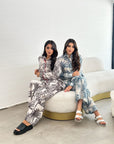 Women's palm print travel wear set with elastic waist trousers and relaxed fit silhouette.