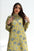 Woman wearing a yellow floral dress against a white background