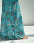 Teal pants with a floral pattern on a white background