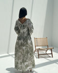Back view of botanical print linen blend jalabiya featuring elegant bow detail and full-length modest design